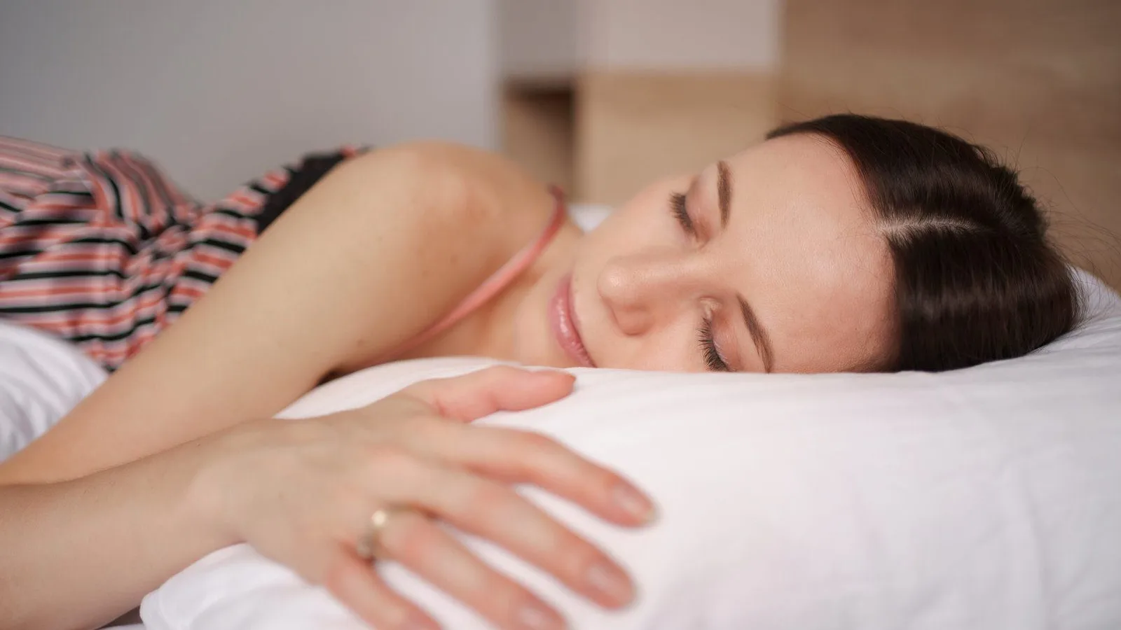 Woman sleeping peacefully in bed at home